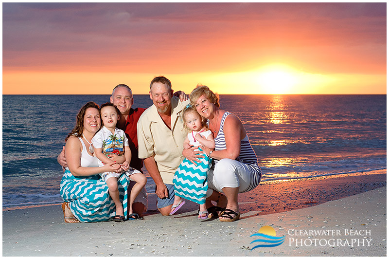 Family in front of beautiful sunset on Clearwater Beach