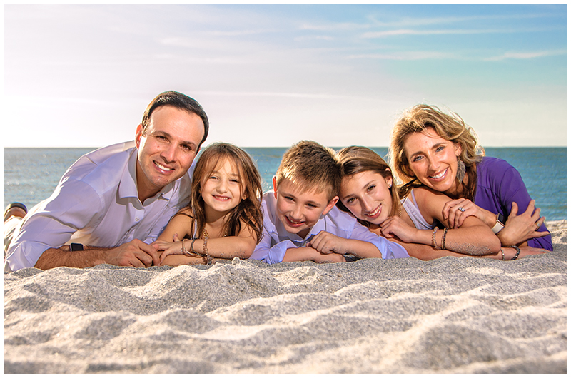 Family lieing in sand on Clearwater Beach